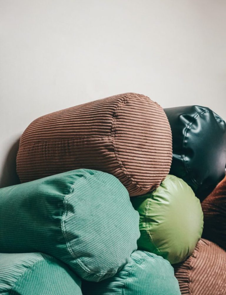 A bunch of pillows are stacked on top of each other